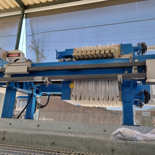 Small automated CakeMax® filter press being used for dewatering sludge form an industrial laundry
