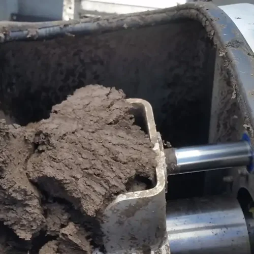 Sludge being discharged from the outlet cone of a screw press